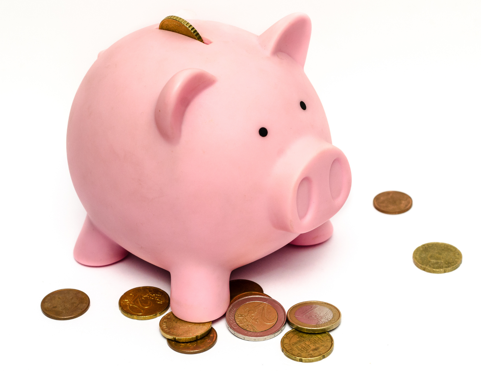 Piggy bank with pennies surrounding it