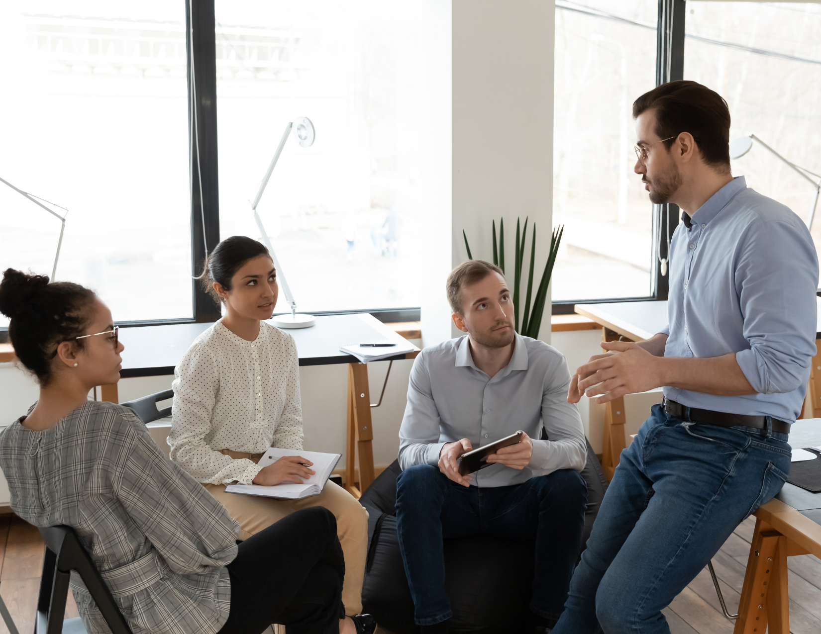 Team of 4 employees working together